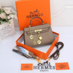 Hermès Kelly 25 Swift Gris Pâle Leather Top Handle Shoulder Hand Bag Gold Hardware Taupe with Free Perfume